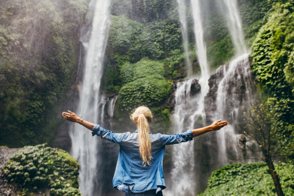 woman looking at waterfall